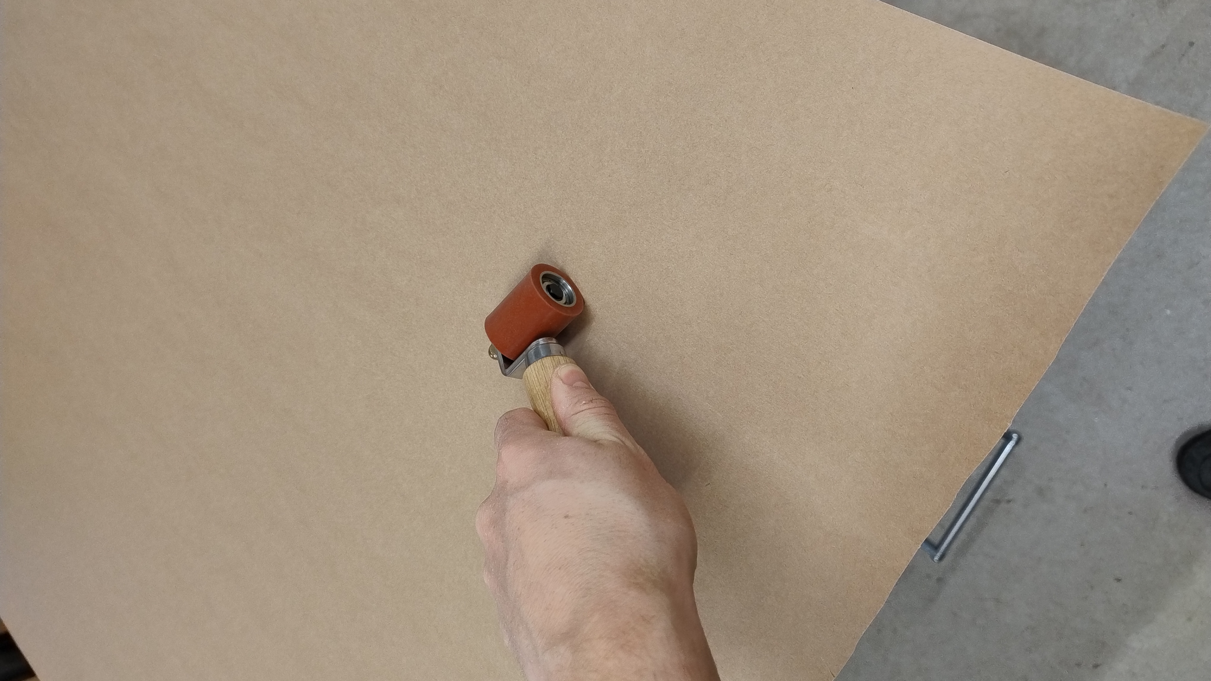 Andrücken des Gegenzugpapiers mit Andrückrolle